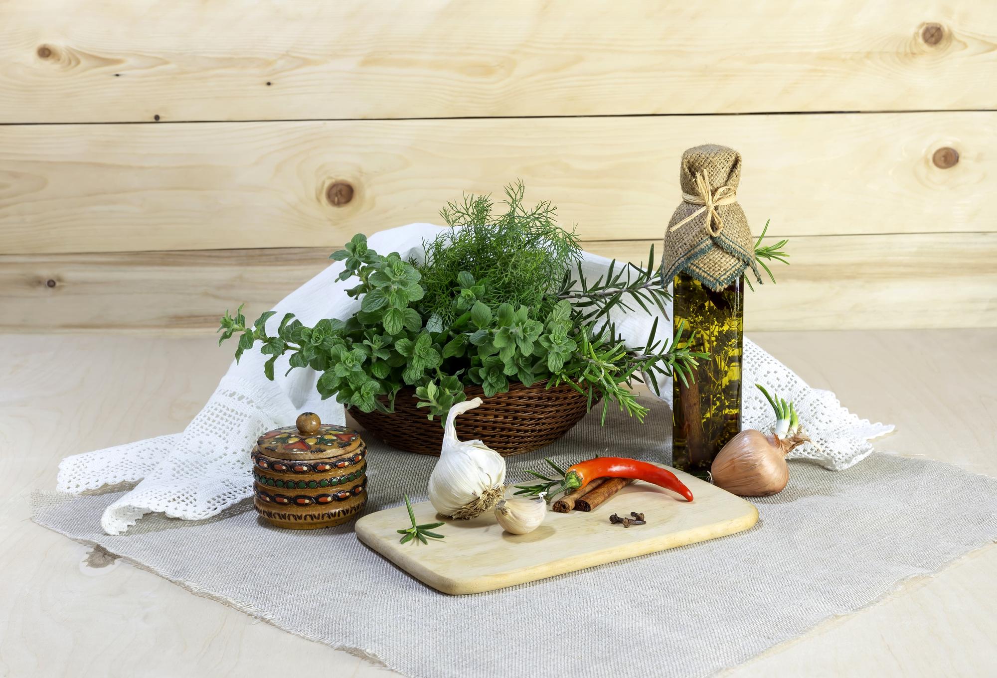 Rustic kitchen table with packaged meal kit and herbs