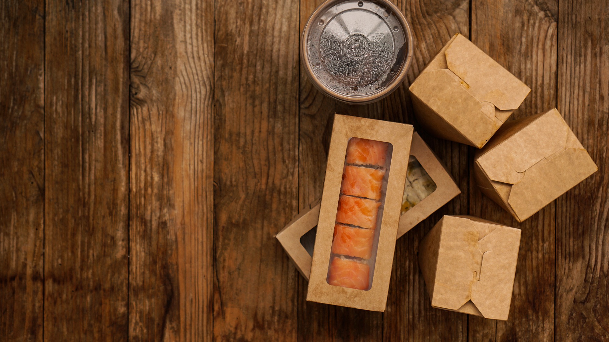 Selection of three meal kit packages on rustic surface